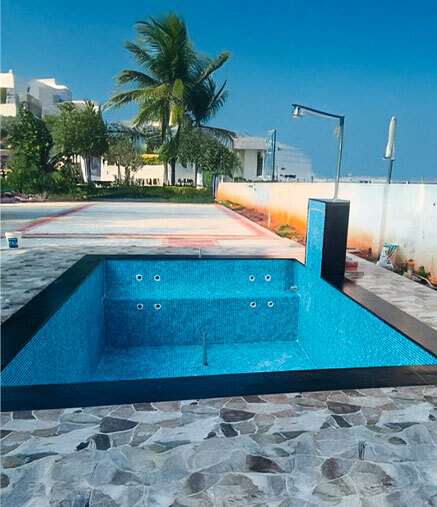 Custom outdoor sunken jacuzzi and plunge pool with blue mosaic tile finish